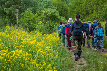 A group of people walking in field of flowers