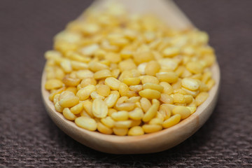 peeled mung beans on wood spoon