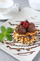 Waffles with chocolate and raspberries.