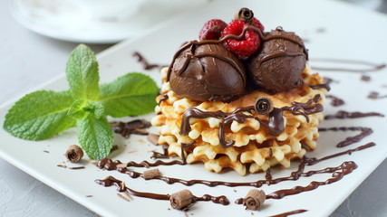Waffles with chocolate and raspberries.