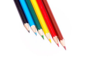 Six colored pencils on a white background. Dark blue, blue, green, yellow, red and brown. Bright colors. Back to school. Stationery.