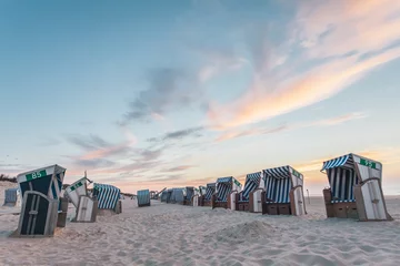 Beach chairs on the island Nordernery in the North Sea during the sunset © grobima