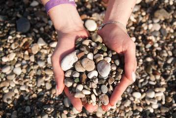 Sea stones in hands sea beach sun summer