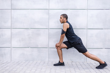 Fototapeta na wymiar african american runner stretching on street