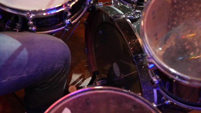Drumming on Stage. Bass drum pedal while playing the drum kit. Slow motion