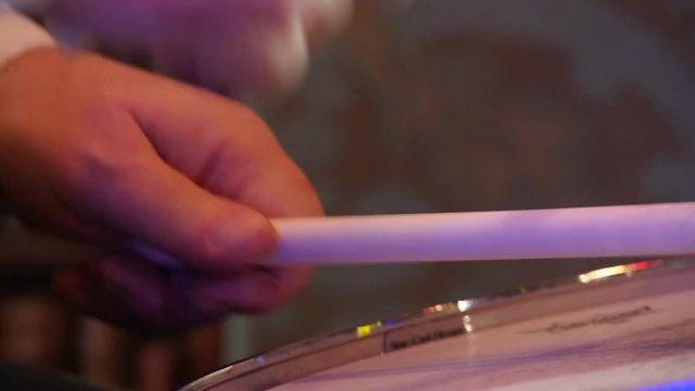 drumsticks in the hands of a drummer, live Jazz concert. Slow motion close-up