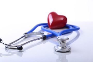 RX prescription, Red heart, asorted pils and a stethoscope on white background