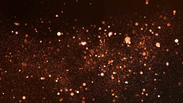 Glittering sparks flying in a blurred background. 4K UHD video loop animation.
