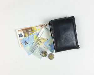 money and wallet on white background - top view