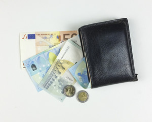 money and wallet on white background - top view