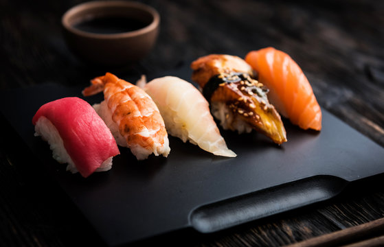 sashimi sushi set with  soy on black background