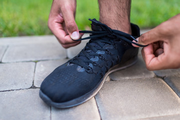 sportsman tying shoelaces