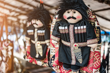 Souvenir bag decorated with a traditionally dressed georgian toy