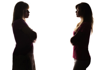 Silhouette standing opposite each other daughter and mother
