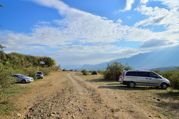 Fototapeta na wymiar The cars in the Parking lot on the mountain road in the valley of ghosts in the vicinity of Alushta