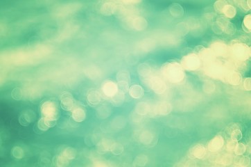 Blur tropical beach with bokeh sun light wave abstract background.