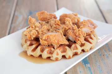 Fried crispy chicken waffle with maple syrup