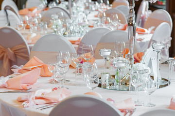 Decoration of the table in a pink style. Wedding decorations in pink tones. Glasses and plates on the layer