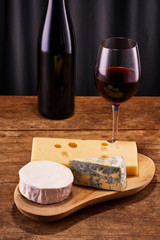 Wine with blue, Camembert and Gouda cheese with copy space