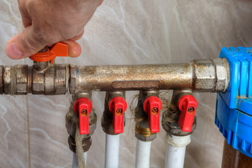 Human hand turn off shut-off valve home water supply.