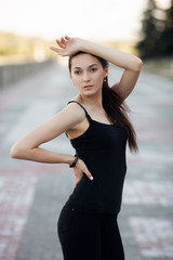 Fashion lifestyle portrait young brunette pretty woman posing in the city quay summer sunset evening showing street fashion ideas