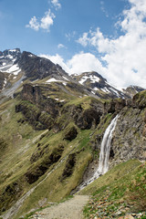 Fototapeta na wymiar Waterfall near Sesvenna Cabin in the Alps, South Tyrol, Italy, Europe