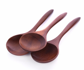 Wooden brown spoon on white background