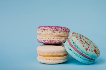 Different types of macaroons on a blue background