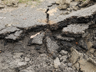 asphalt damage with cracks at street