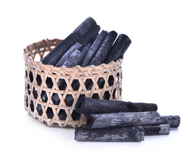 Charcoal  in a bamboo basket on white background