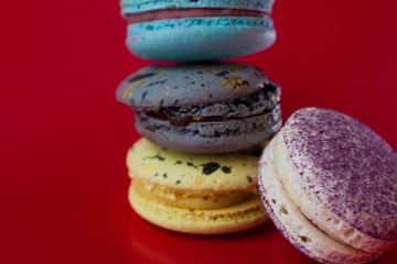 Macarons on red background, Beautiful dessert. Three in a column, one near