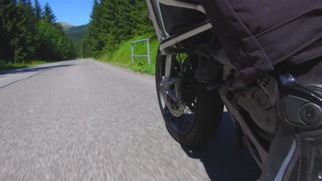 Bottom view of motorcycle wheel on rural road in Czech Republic