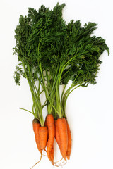 Fresh raw carrots isolated on a white background.