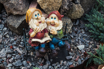 handmade statue of small gnome in garden - obrazy, fototapety, plakaty