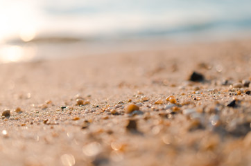Blur tropical sunset beach with bokeh sun light sand abstract background.