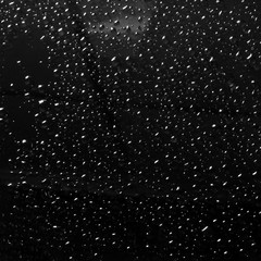 drops of rain on car window pane