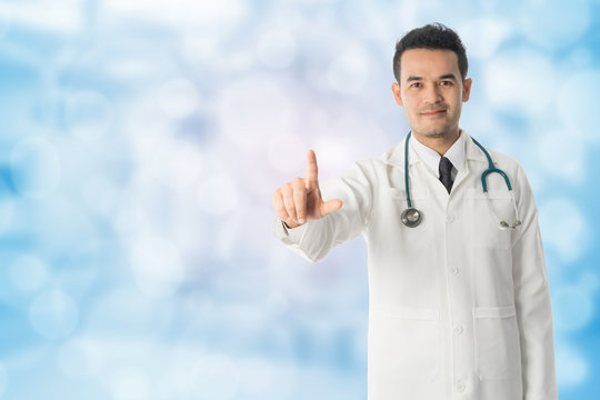 Male Doctor Pointing Finger At Copy Space.