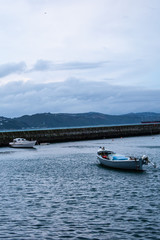 Fototapeta na wymiar Two Small Boats in Harbor
