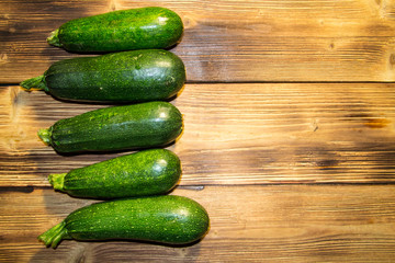 Fresh zucchini on wooden table. Top view