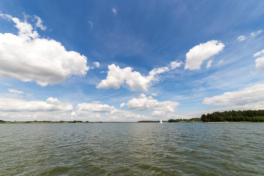 Landscape with lake in summer. Blue sky