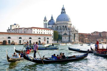 Fototapeta na wymiar Venice, Italy - July 20 2017 : Gondola on Canal Grande with Basilica di Santa Maria della Salute in the background, Venice, Italy