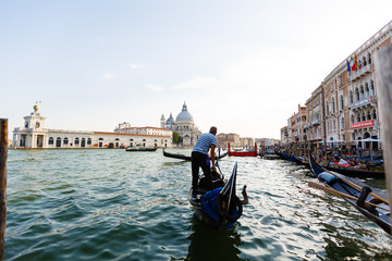Fototapeta na wymiar Gondola on Canal Grande with Basilica di Santa Maria della Salute in the background, Venice, Italy