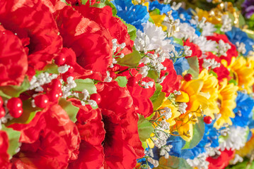multicolor artificial flowers, made of fabric, background, focus selection