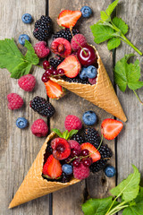 Selection of berries in ice cream cones - healthy dessert concept