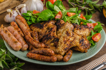Grilled chicken wings and sausages