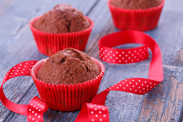 Red muffins on a wooden table
