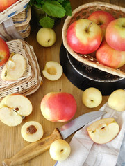 Apples and white nectarines on a wooden table and in wicker baskets. Fresh harvest. View from above