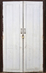 Wooden white door with key locked.