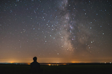 Man under the center of our home galaxy, the Milky Way galaxy, night stars landscape