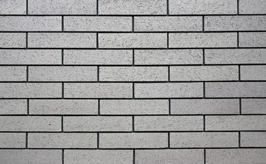 Horizontal grey brick wall background.